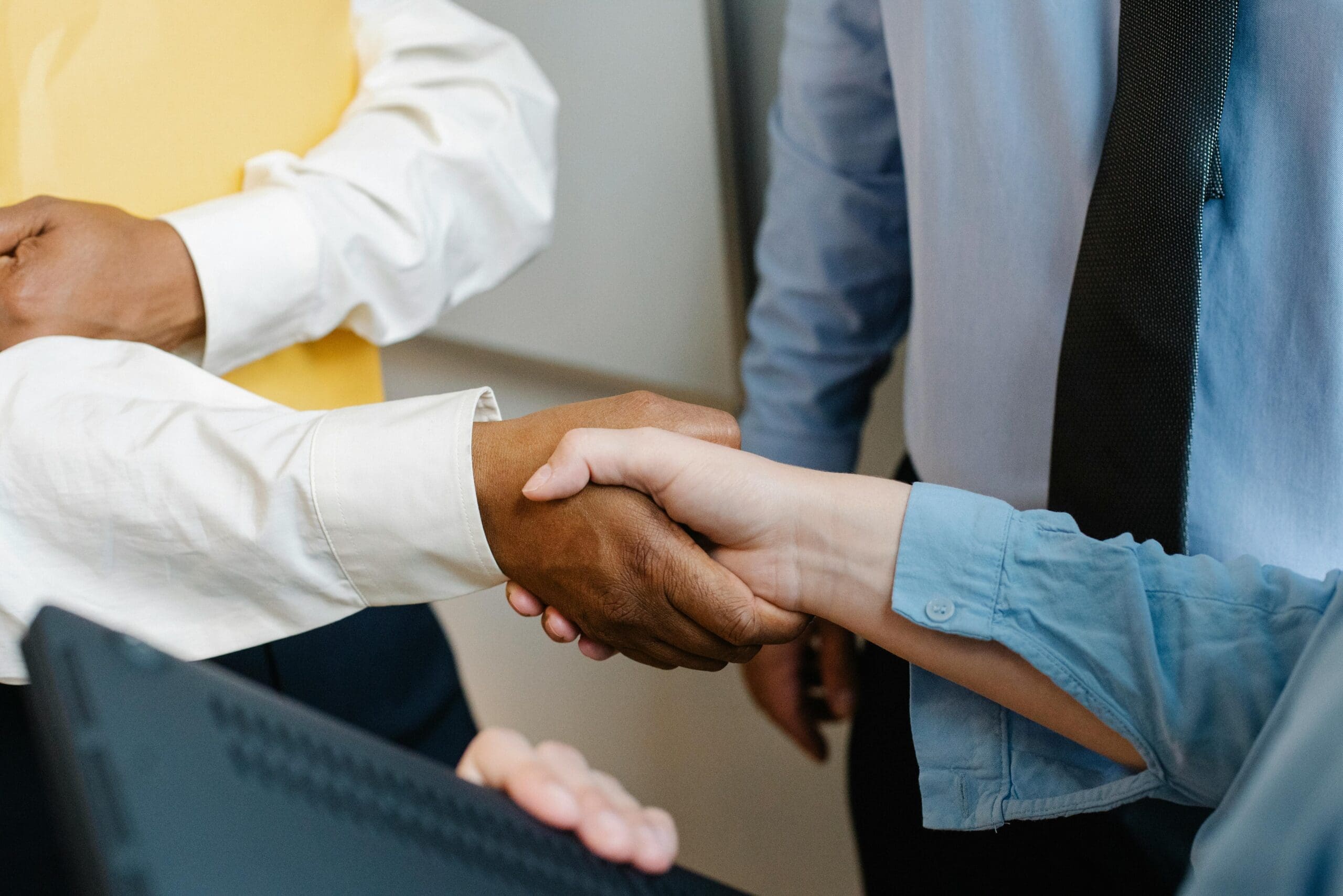 Professional handshake at business meeting, diverse partnership and teamwork concept, corporate agreement